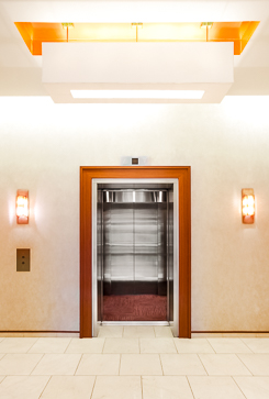 A photo looking into the interior of an open elevator cab.